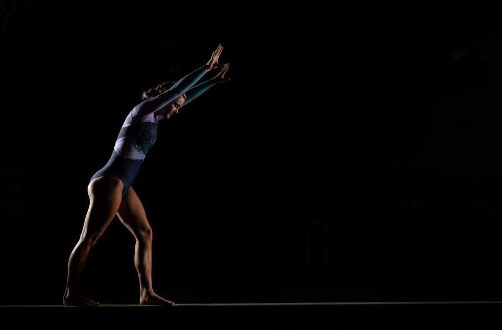 Senior gymnast performing on beam at Summit Academy gym in Fort Wayne, capturing her athleticism and energy."