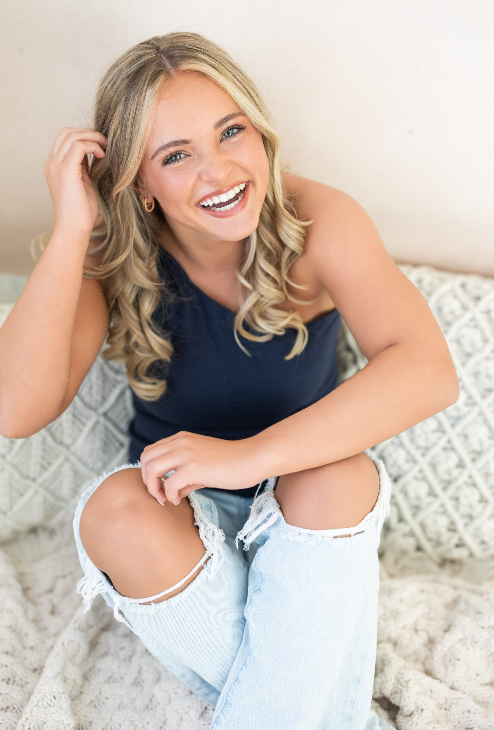 Senior girl laughing naturally at the camera in studio in Fort Wayne.