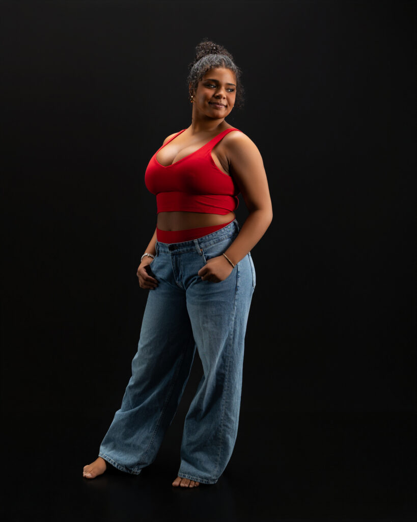 dancer doing an artistic pose wearing jeans and an athletic set in fort wayne